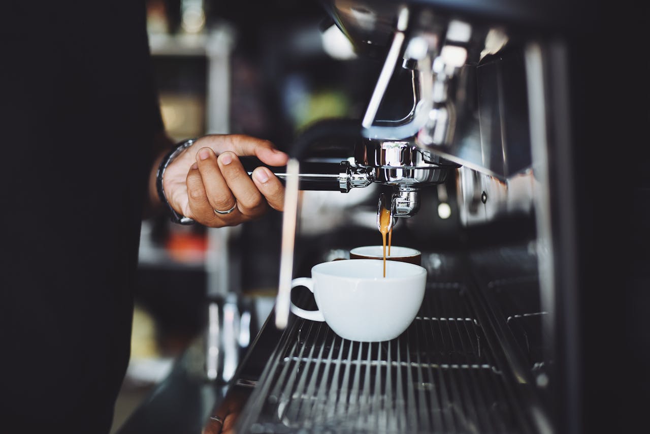 brand-02 Close-up of a barista preparing espresso in a café using a machine